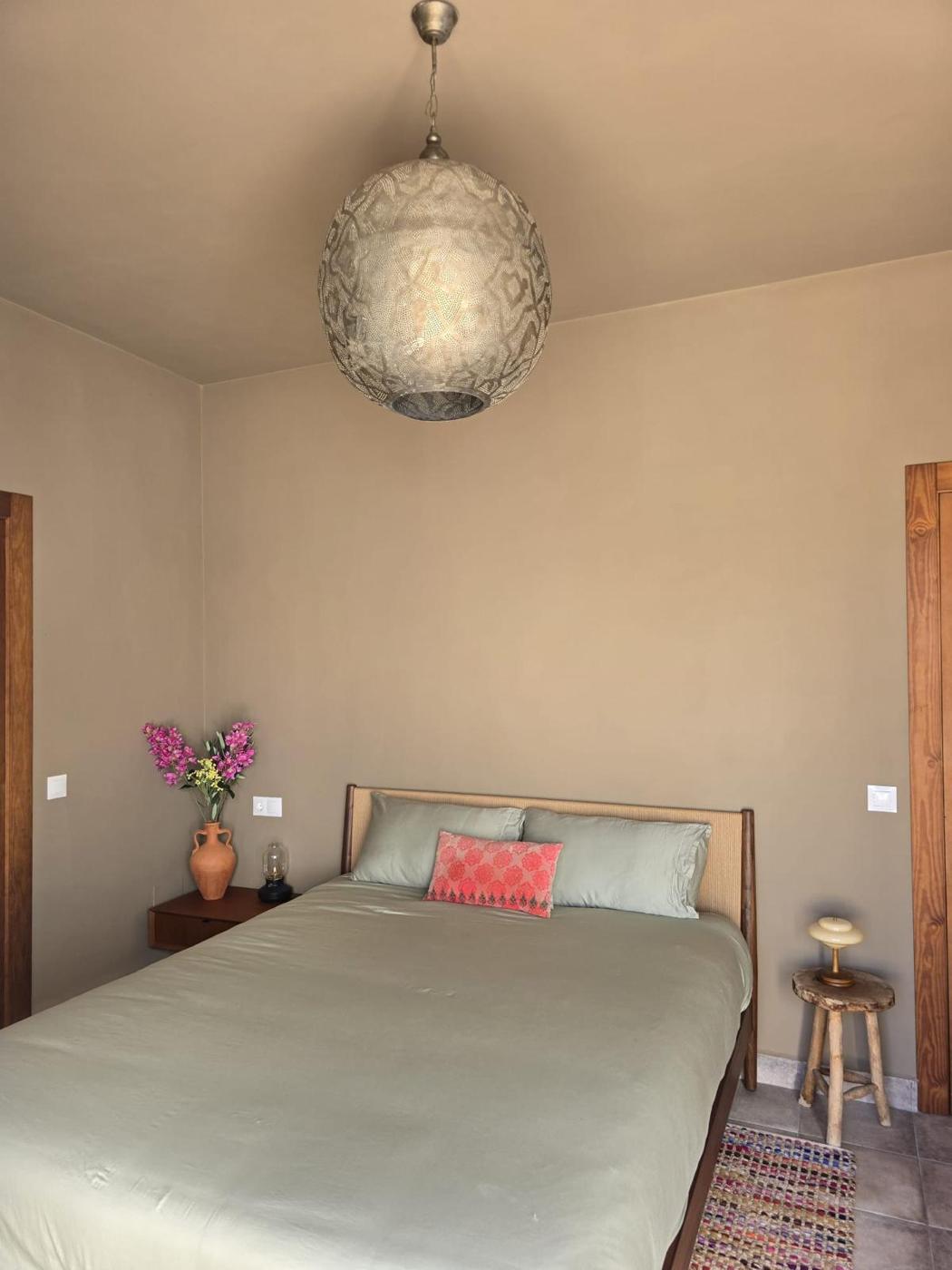 Bedroom with a Moroccan brass pendant lamp