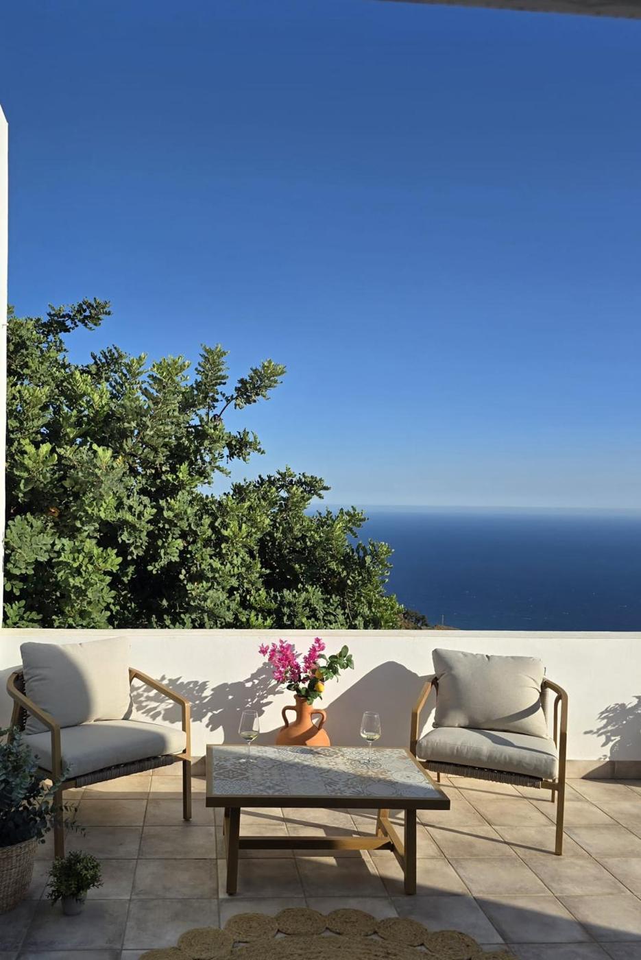 Roof terrace at Alma del Almendral with two chairs and a view of the Mediterranean